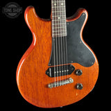 Electric guitar with a sunburst finish on a black background, featuring the Tone Shop logo.