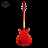 Red electric guitar on a black background with 'Tone Shop' logo.