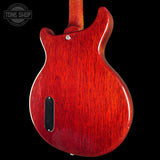 Red electric guitar body on a black background with 'Tone Shop' logo.
