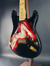 Guitar with a red and black design on a gray background