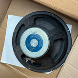 A vintage black speaker driver with a blue and white center label reading 'SMITHWAVES ELECTRICS', resting on a white sheet of paper inside a brown cardboard box.
