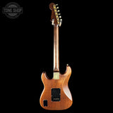 Wooden electric guitar on a black background with 'Tone Shop' logo.