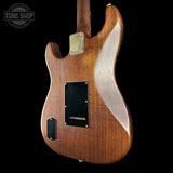 Wooden electric guitar body with a visible brand logo in the corner.
