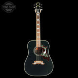 Acoustic guitar with floral design on a black background, featuring the Tone Shop logo.