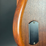 Wooden handle with a metal tag on a wooden surface