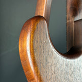 Close-up of a wooden violin's f-hole on a gray background