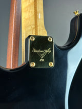 Close-up of a guitar with a brand logo on the headstock.