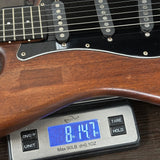 Digital scale displaying weight on a guitar