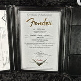 Fender certificate of authenticity in a black leather case on a dark background