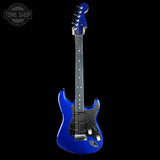 Blue electric guitar on a black background with 'Tone Shop' logo.