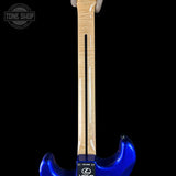 Blue electric guitar with a visible brand logo on a black background