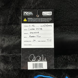 Close-up of a guitar label with text and branding on a textured black background