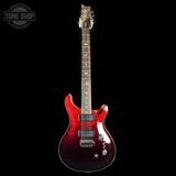 Red electric guitar on a black background with 'Tone Shop' logo.