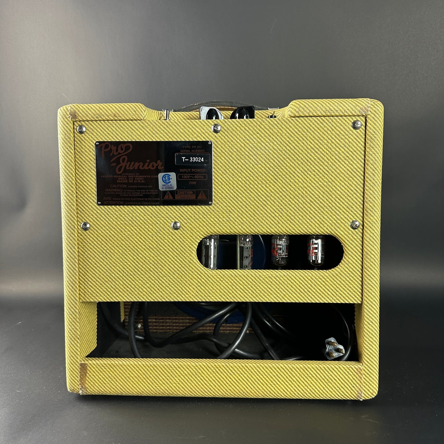Yellow guitar amplifier with visible branding on a gray background