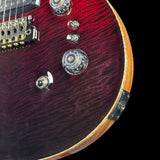 Close-up of a red electric guitar with wood finish on a black background