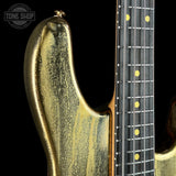 Front of left horn of Ernie Ball Music Man 50th Anniversary StingRay Molten Gold.