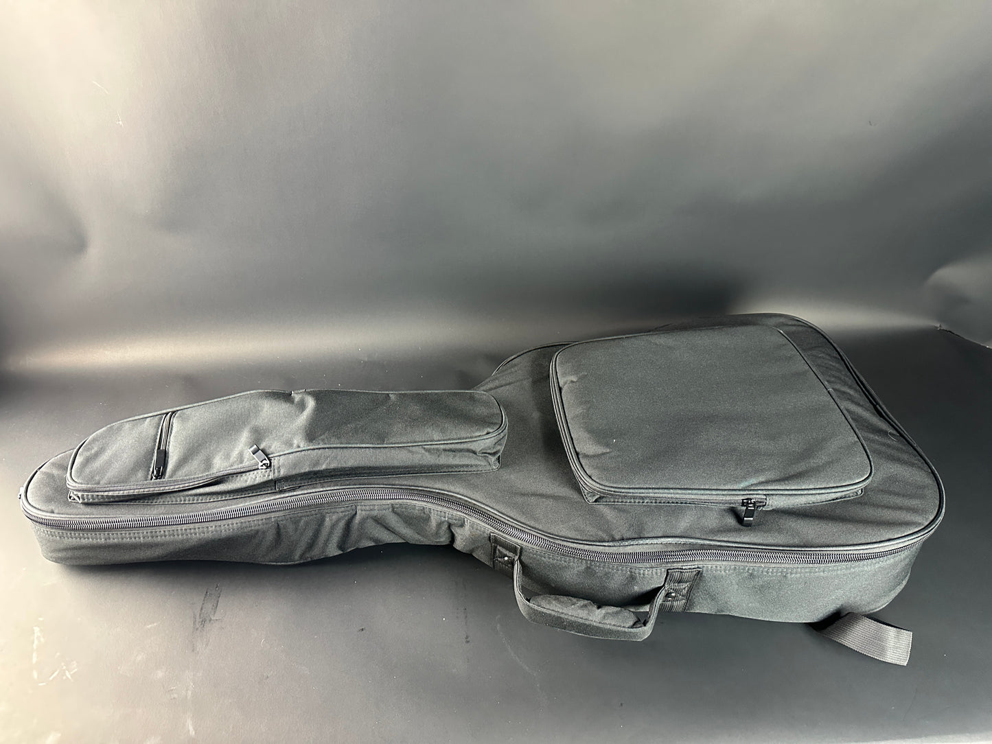 Gray guitar case on a gray background