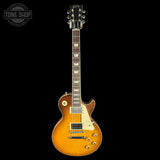 Electric guitar with a sunburst finish on a black background, featuring the Tone Shop logo.