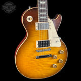 Electric guitar with a sunburst finish on a black background, featuring the Tone Shop logo.