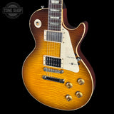 Electric guitar with a sunburst finish on a black background, featuring the Tone Shop logo.
