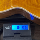 Gibson Les Paul Standard 50s Figured Top Honey Amber on scale displaying weight.