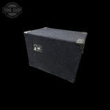 A black textured speaker cabinet or subwoofer box shown at an angle against a solid black background, with a Tone Shop watermark in the top-left corner.