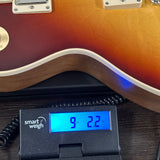 Gibson Les Paul Standard 60s Faded Vintage Bourbon Burst on scale displaying weight.