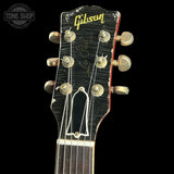 Gibson guitar headstock with logo on a black background