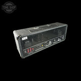 Guitar amplifier head with control panel on a black background, featuring the Tone Shop logo.