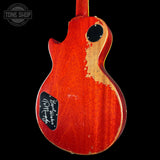 Red electric guitar body with a visible brand logo on a black background