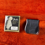 Fender guitar string set packaging on a wooden surface
