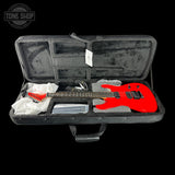 Red electric guitar in a black case with accessories on a white background