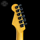 Guitar headstock with tuning pegs on a black background, featuring the Tone Shop logo.