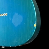 Close-up of a blue guitar with visible wear and tear on the body.