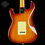 Fender electric guitar body with a sunburst finish on a black background