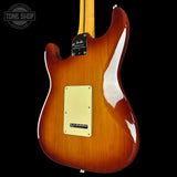 Glossy brown electric guitar with a visible brand logo on a black background