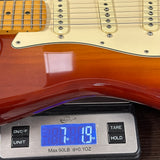 Guitar on a digital scale displaying weight