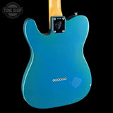 Blue electric guitar body with a visible brand logo on a black background