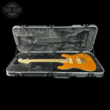 Electric guitar in a hard-shell case with 'Tone Shop' logo.