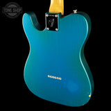 Blue electric guitar body with Fender logo on a black background
