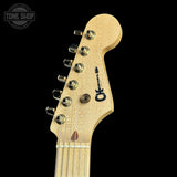 Guitar headstock with brand logo on a black background
