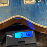 Gibson Les Paul Standard 50s Figured Top Ocean Blue on scale displaying weight.