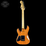 Wooden electric guitar on a black background with 'Tone Shop' logo.