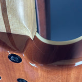 Close-up of a wooden guitar's soundhole and bridge
