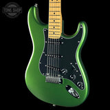 A metallic green electric guitar with a black pickguard and maple neck, shown against a solid black background with a Tone Shop watermark in the top-left corner.