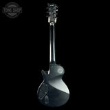 Silver electric guitar on a black background with 'Tone Shop' logo.