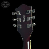 Close-up rear view of a guitar headstock on a black background, showing six silver tuning pegs and white printed text reading 'CJH-2000SSE' and 'CALIFORNIA MADE IN CHINA'. A Tone Shop watermark is visible in the upper left corner.