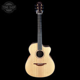 Acoustic guitar with a visible brand logo on a black background
