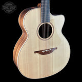 Acoustic guitar with a visible brand logo on a black background
