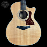 Acoustic guitar with a visible brand logo on a black background